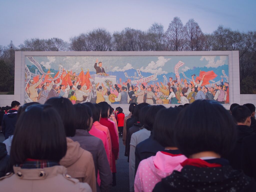 people in North Korea, including persecuted Christians, view a mural