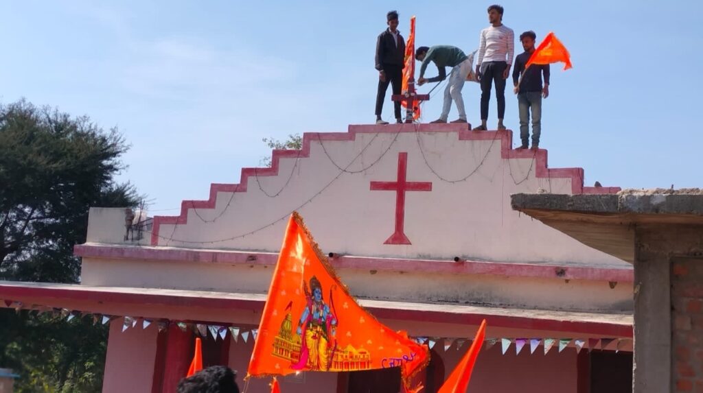 persecuted believers from India watch as mob plants flag on church