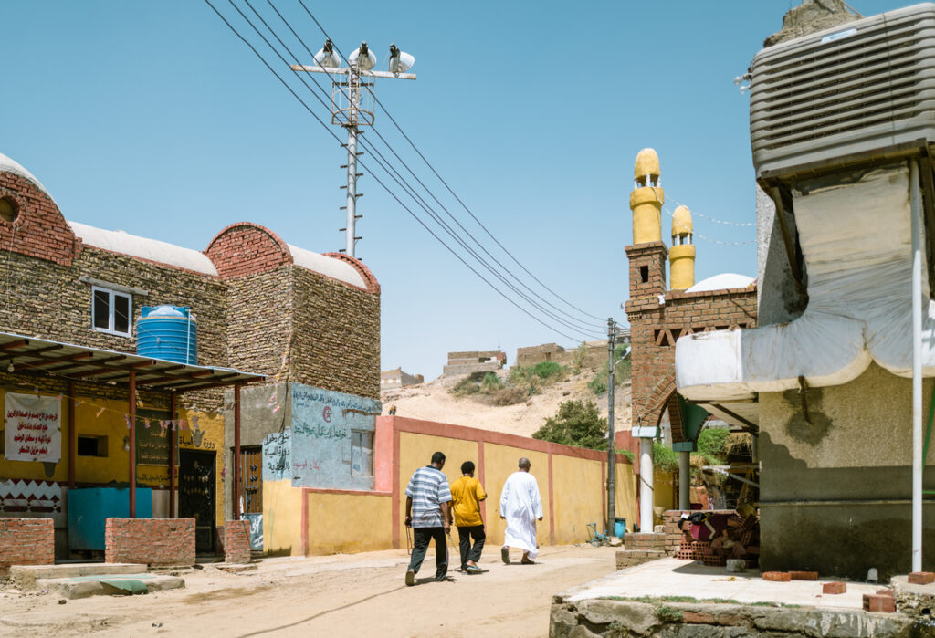 Men walking through Egyptian village