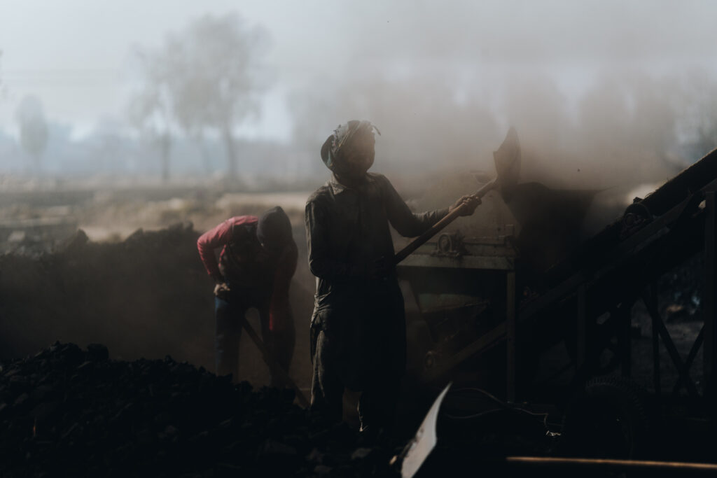Two believers enduring Christian slavery shovel coal in Pakistans brick kilns