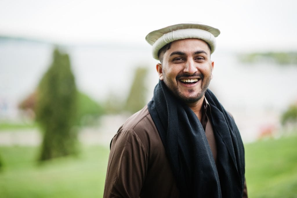 A smiling Pakistani man.