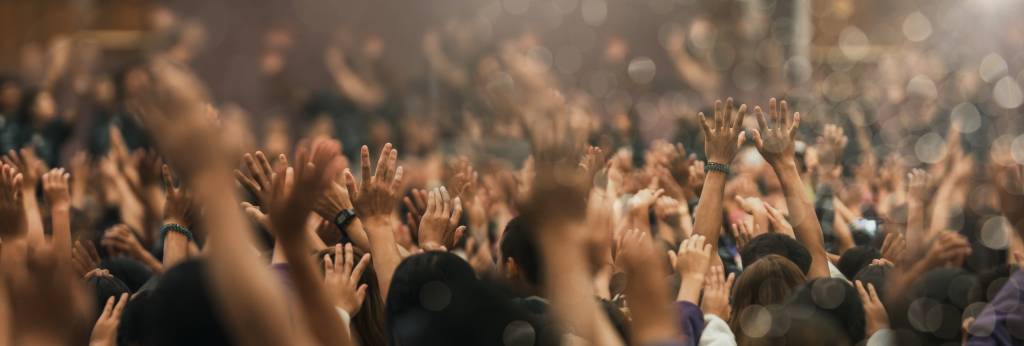 Many people raising their hands in worship