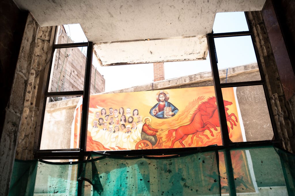 A view through a broken window of the damaged Mar Elias Church in Damascus, Syria.