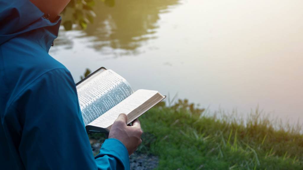 Someone reading the Bible for strength in hard times.