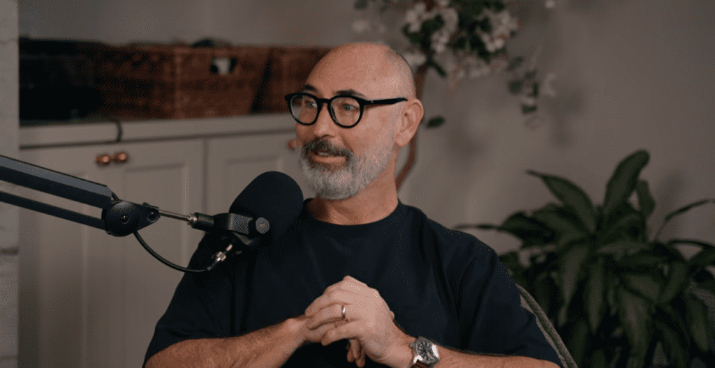 Brian Orme speaking into a podcast microphone