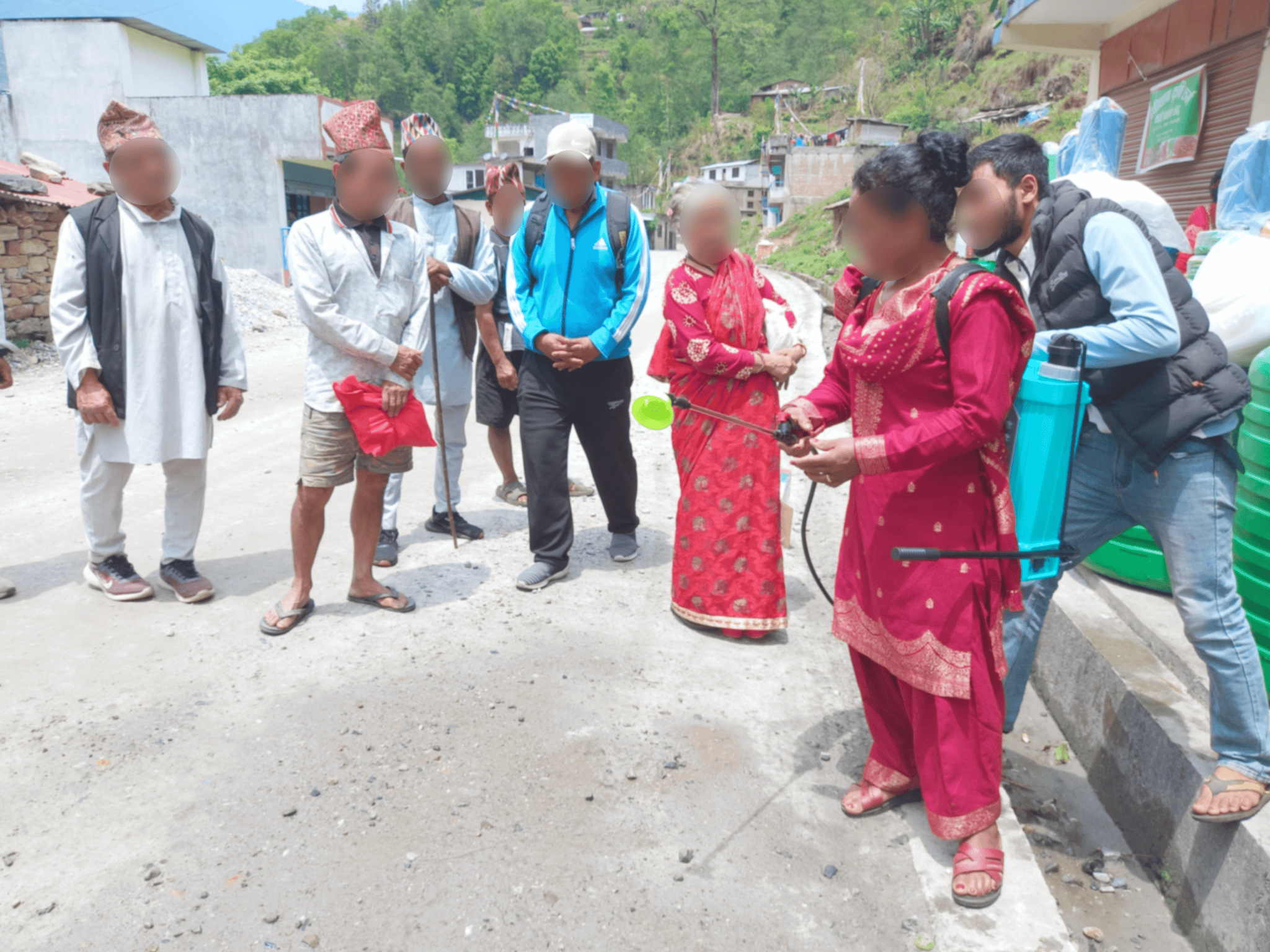 Families in Nepal learning how to use their new greenhouse equipment